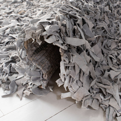 Tapis décoratif moderne SAFAVIEH en cuir shaggy fait main Doinita