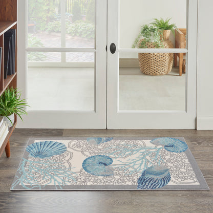 Tapis d'intérieur/extérieur Waverly Sun &amp; Shade Shore Thing Tropical Sea Shell Floral